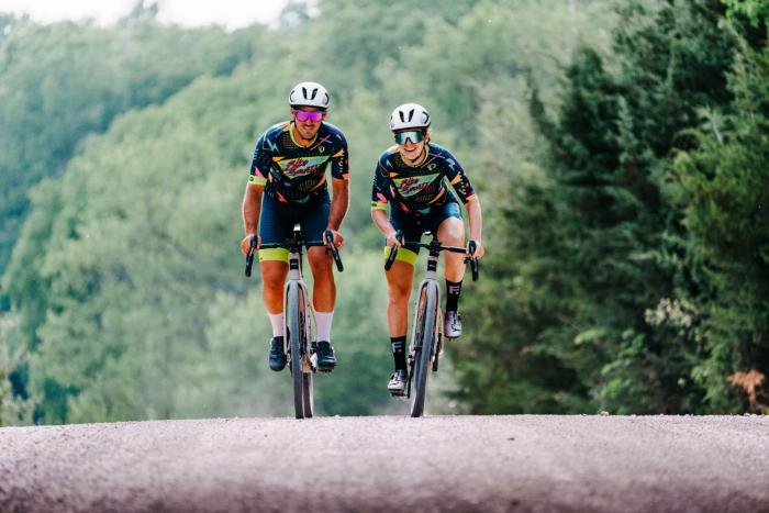 Two bicyclists pedaling towards the camera