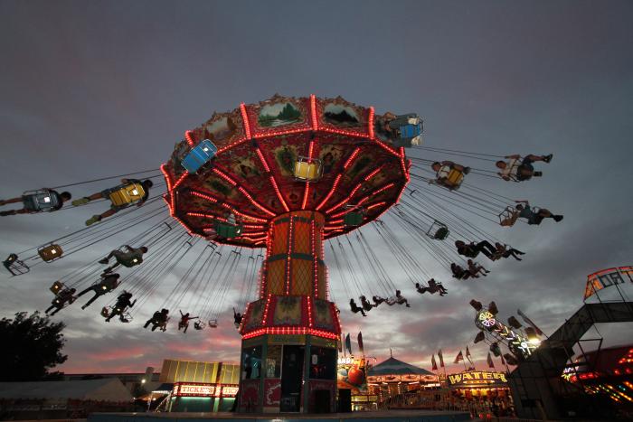 People riding swings mid-air