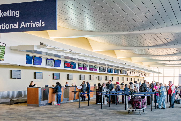 passengers in line to get flight tickets in main concourse