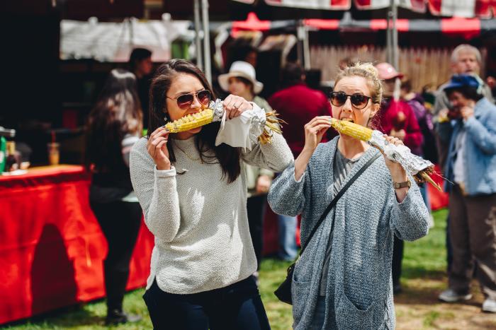Two Guests Eating Corn on the Cob at the Rochester Lilac Festival