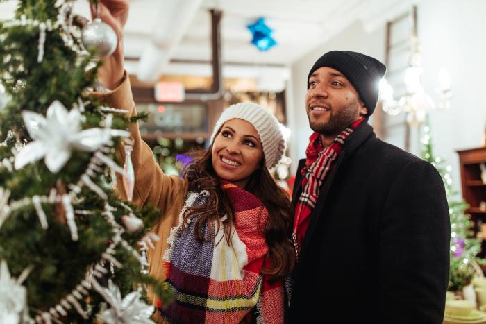 Couple at Stroll on State next to tree