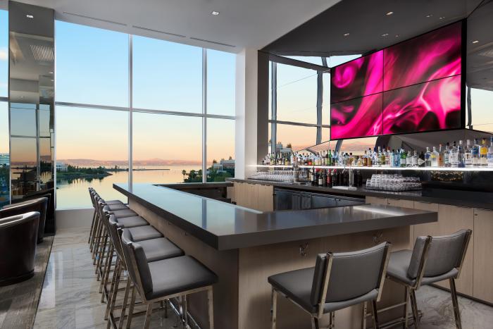 View of the bar lounge in the AC Hotel Airport Oyster Point Waterfront.