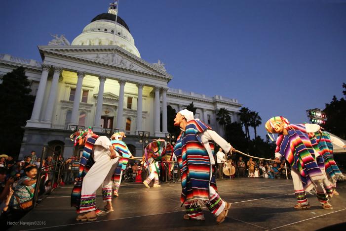 people at a cultural event in front of california's capitol building