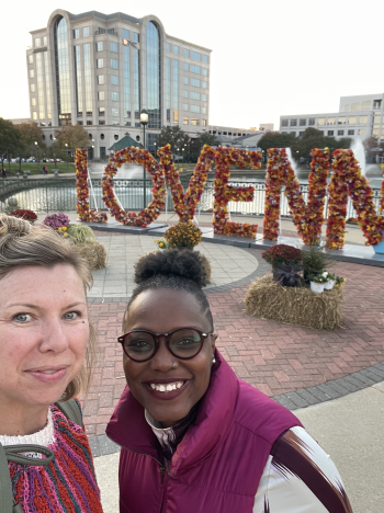 Jackie and Hannah pose in front of the LOVENN sign at City Center
