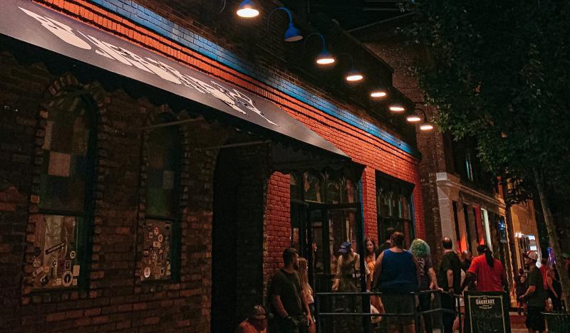 People gathered outside of The Bluebird's doors at night