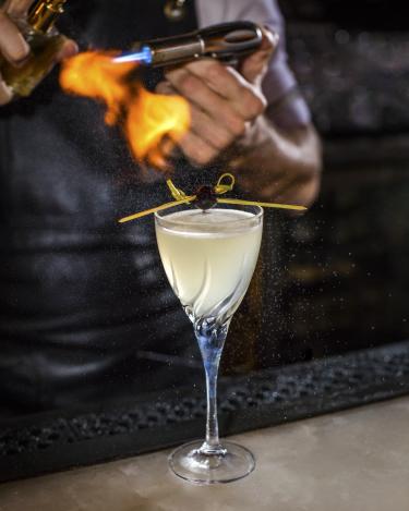 Corpse Reviver number 2 cocktail with gin triple sec cocchi americano lemon and flamed absinthe from the Roosevelt Room in Austin Texas
