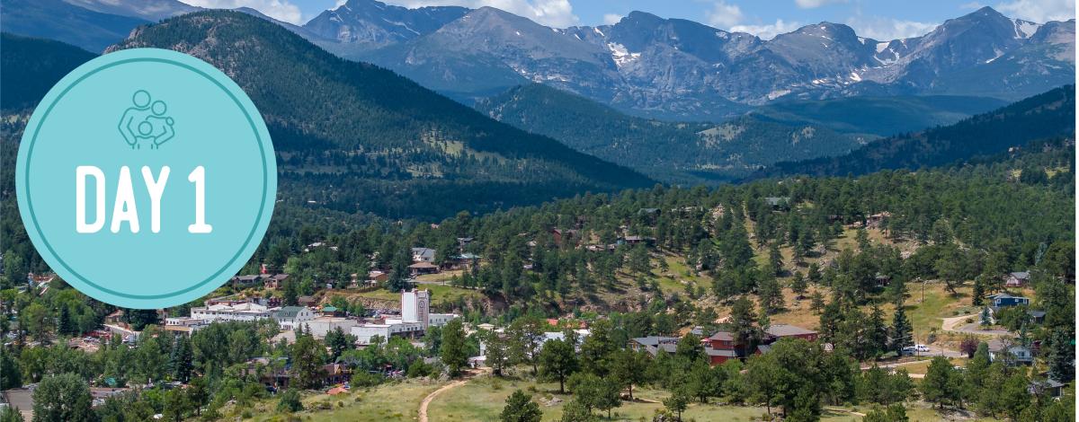 Day 1 in a circle on the left. Picture of downtown Estes Park with the mountains in the background