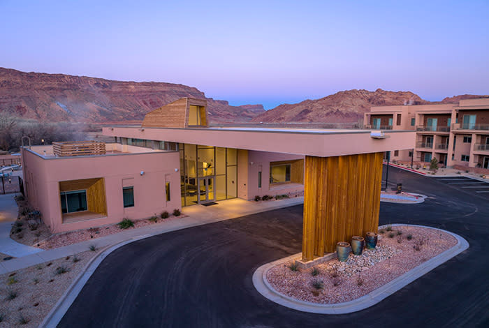 The exterior of the WorldMark Moab Resort at sunrise.