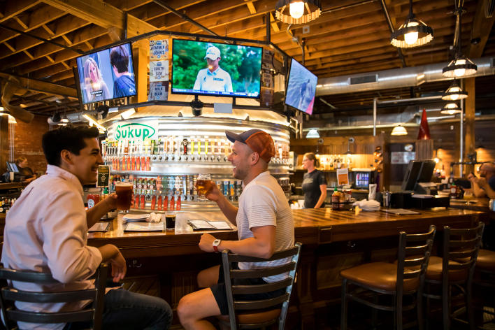 A pair of friends enjoying a beer at Iowa Taproom