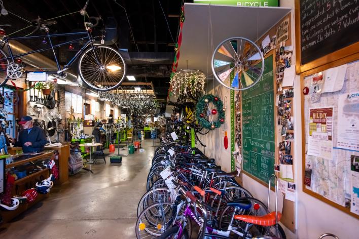 Bikes lining the walls and hanging from the ceiling at Ichi Bike