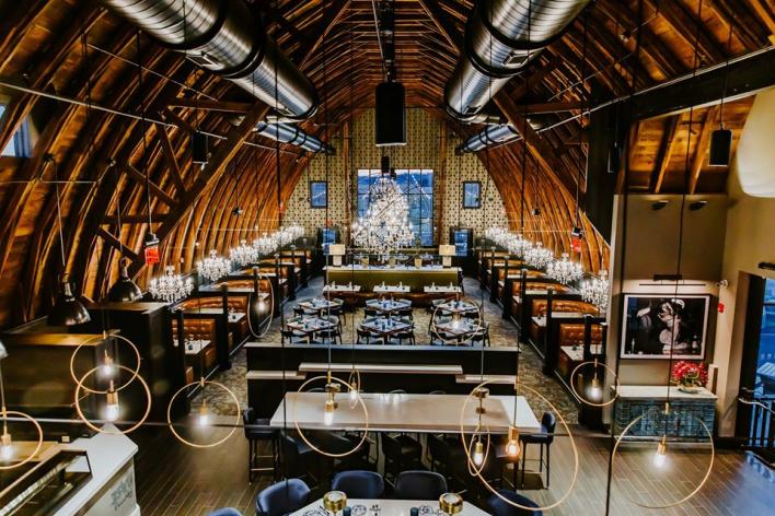 Interior view of Black Sheep Restaurant with tables and chandeliers