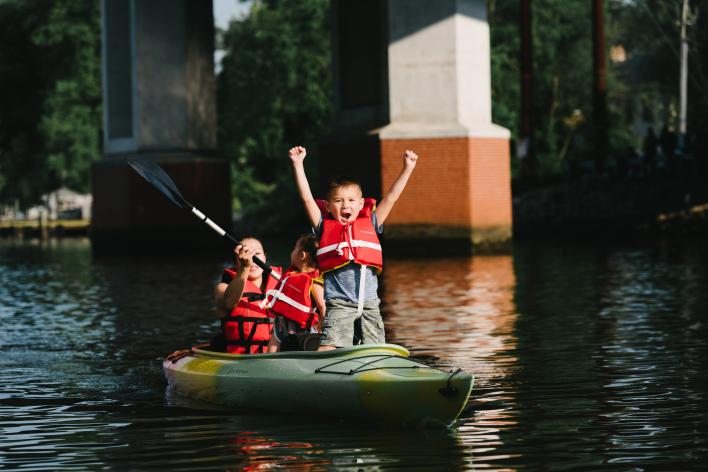 A woman and two children kayaking