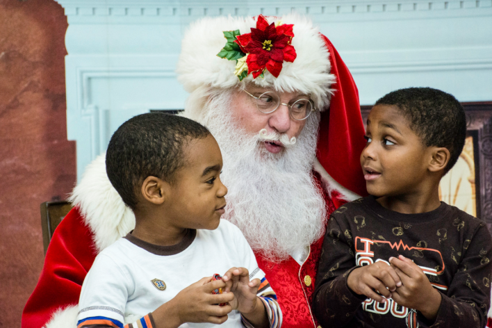 2 black boys sitting on Santas lap