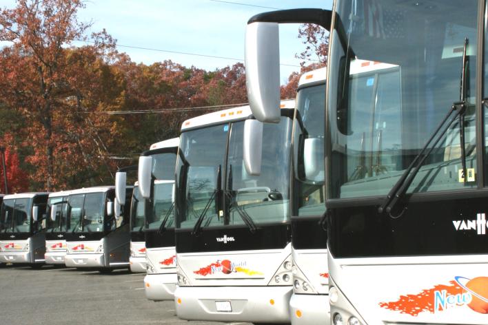 Motor coaches lined up in a parking lot