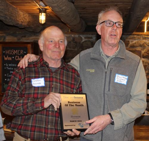 Cameron Hosmer & Bruce Murray pose with Hosmer's March 2022 Business of the Month Plaque