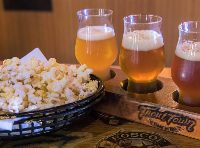 A flight of beers next to a basket of popcorn at Roscoe Beer Co. in the Catskills