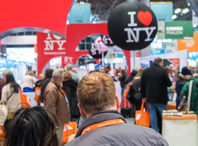 A couple enter the New York Times Travel Show at the Javits Center