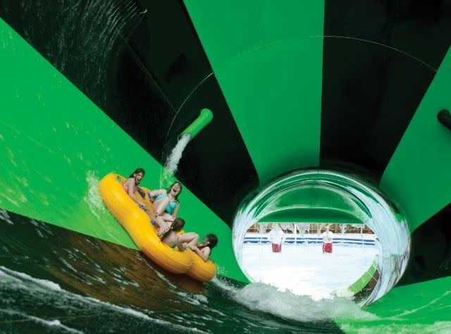 Four people ride the Alien Invasion water slide at Splish Splash Water Park