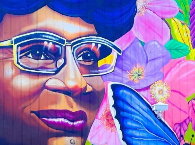 a multicolored mural of shirley chisholm in shirley chisholm state park
