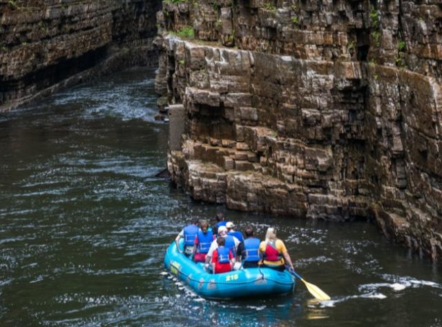 People in a blue raft in Ausable Chasm