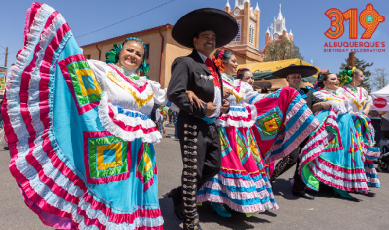 A picture of Mexican dancers in front of San Felipe de Neri Church.