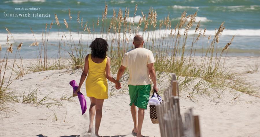 Couple walking hand in hand on Ocean Isle Beach