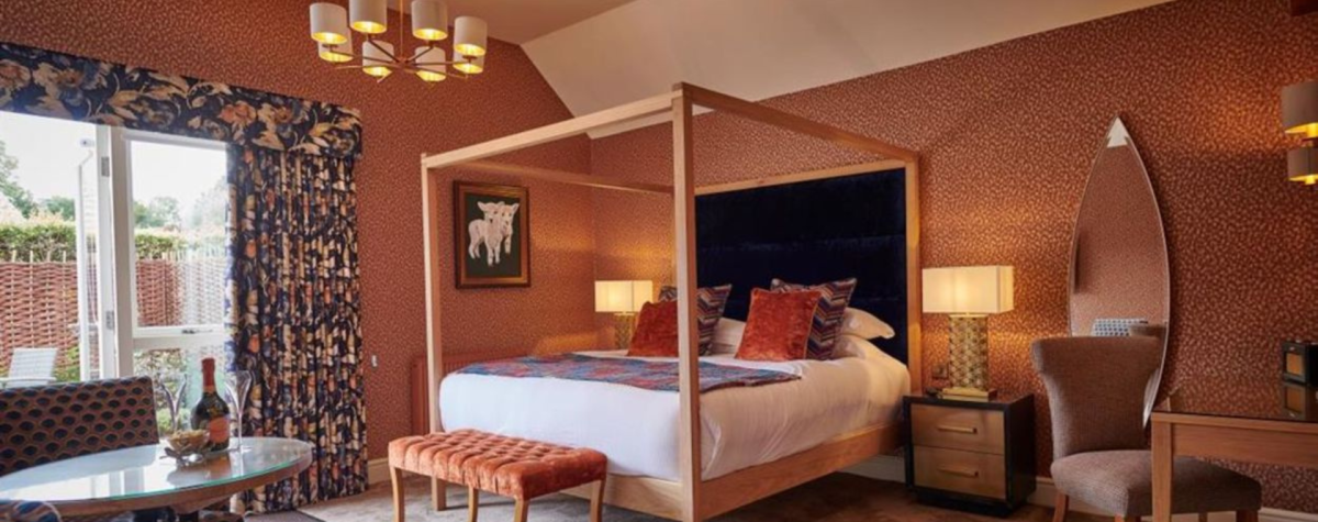 A bedroom at Pipe and Glass, complete with four poster bed.