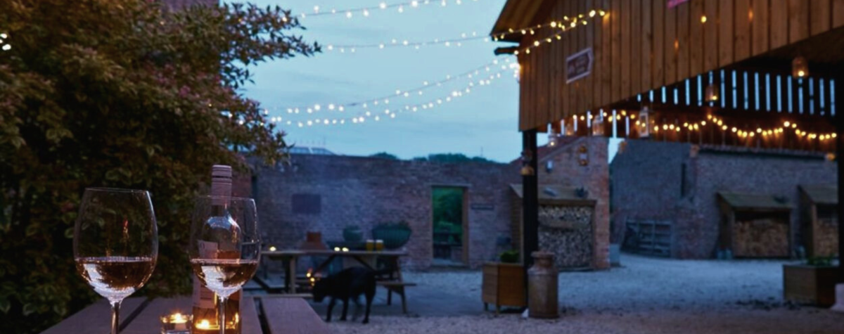 The exterior of some of the accommodation at Dale Farm Holidays lit up with fairy lights
