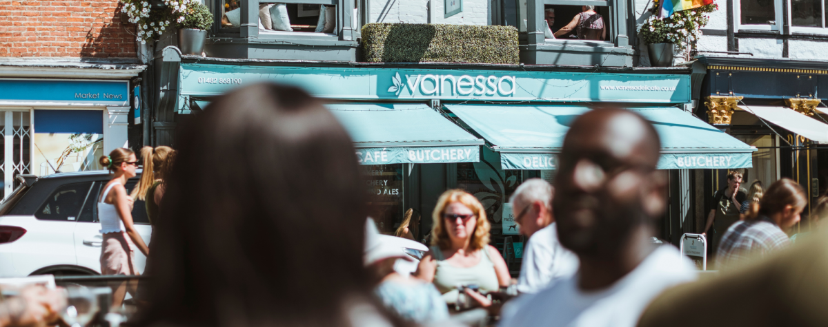 People sat in the sunshine outside Vanessa in Beverley