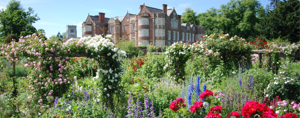 Burton Agnes Hall in the distance with beautiful flowering gardens.