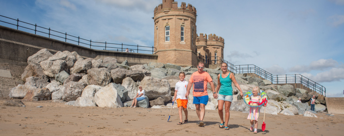 A family walking on Withernsea beach