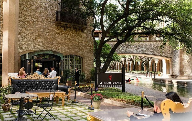 The exterior of Venetian Terrace with the Mandalay Canal in the background in Irving, TX