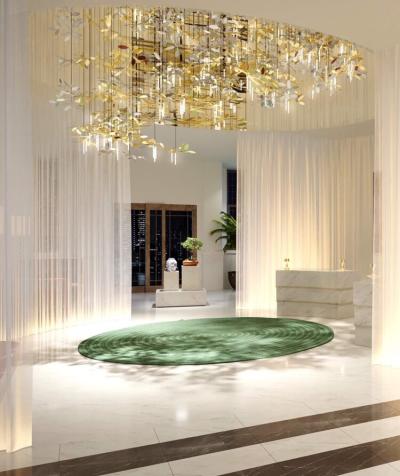 room with sheer curtains, a round, rug and chandellier