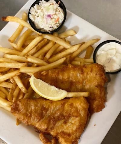 Fish Fry special at Ray J's featuring two pieces of pollock, French fries, cole slaw and tartar sauce with a lemon slice.