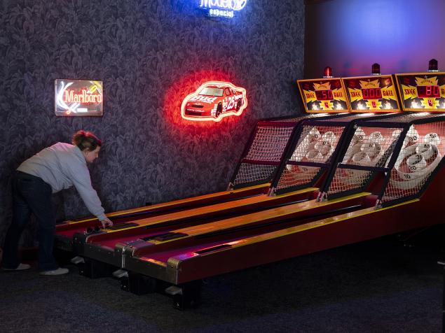 A woman plays skeeball at Old Skool Bar in Downtown Kalamazoo.