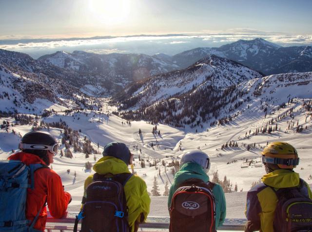 Skiers overlooking the snow-covered mountains at Snowbird