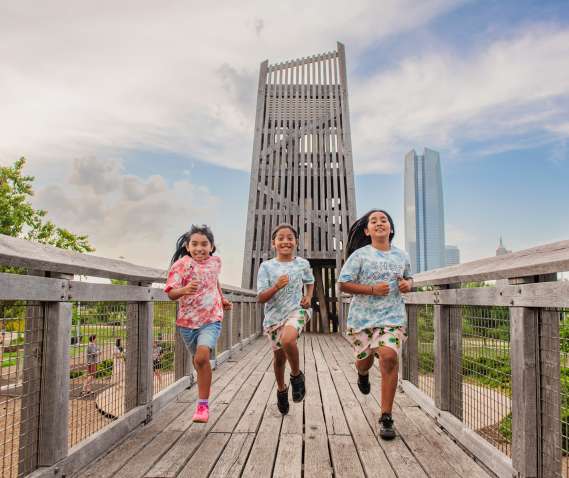 3 kids running at the playground at Scissortail Park in Oklahoma City