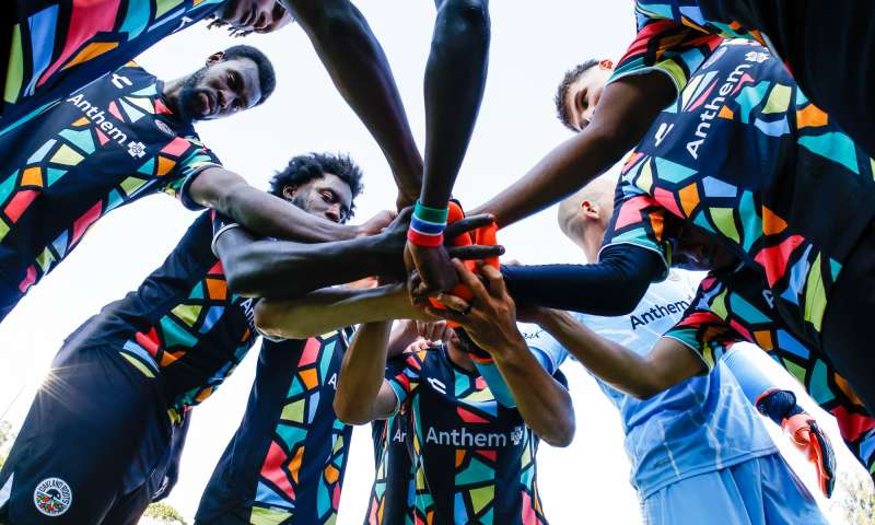 Oakland roots squad getting ready to enter the game