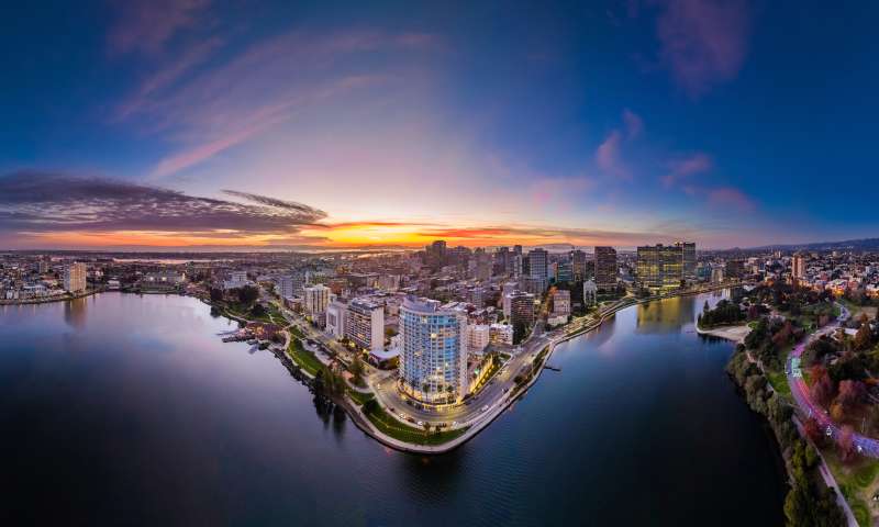 Aerial shot of Lake Merritt with Downtown Oakland in the background during a sunset