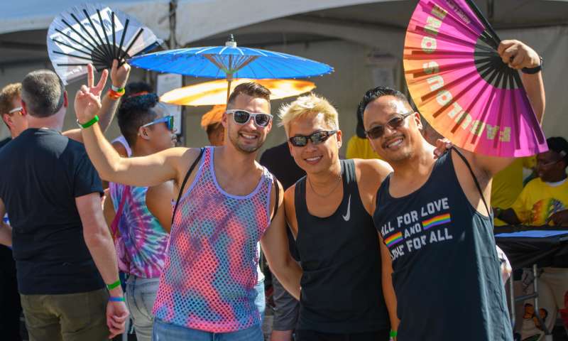 Three friends having a great time at pride parade and festival in oakland california