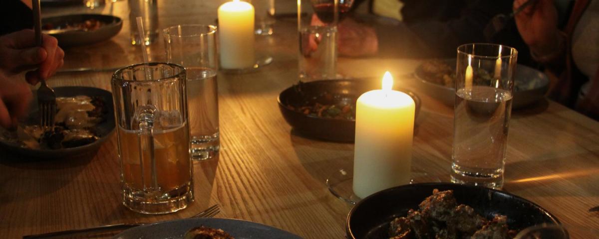 Candles illuminate a table at First Mile Kitchen