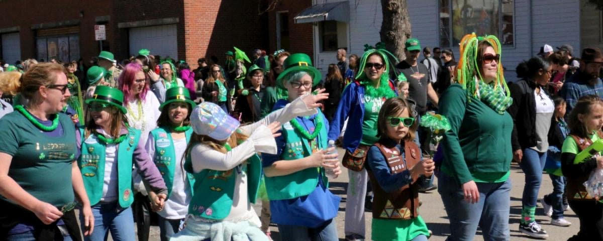 A group of people dressed in green walk in the St. Patrick's Day parade in Delano