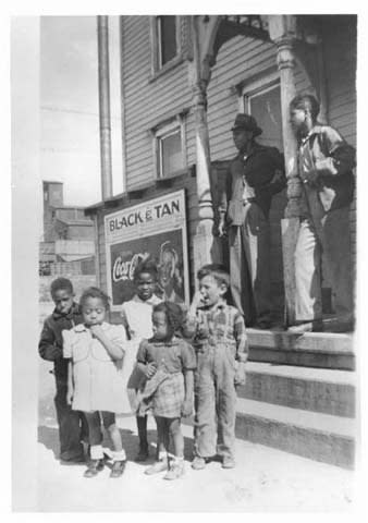 Children stand in front of the Black and Tan in Cheyenne, Wyoming