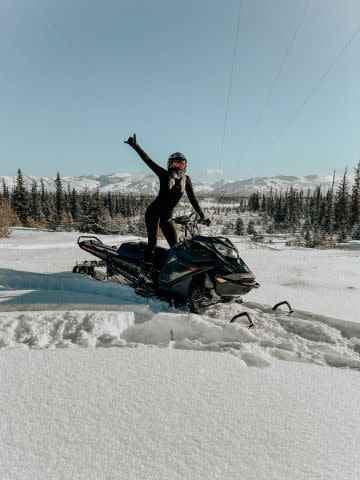 Girl on Snowmachine on a bright sunny day