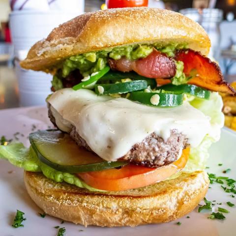 Guru Burgers and Crepes hamburger with cheese, jalapenos, tomatoes, bacon and lettuce