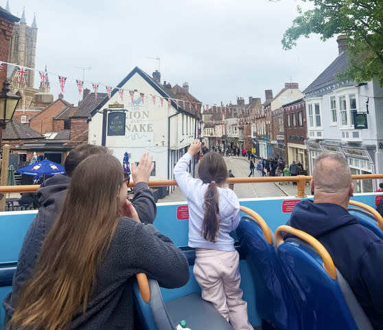 Image shows 3 people on the Lincoln BIG Tour bus.