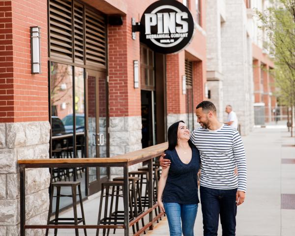 A couple walking hand in hand by PINS Mechanical Company