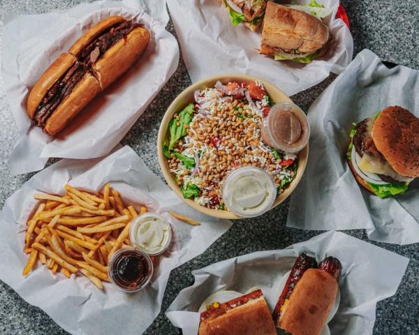 sandwich plates circulating a side of fries and a salad dish
