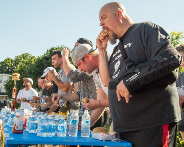 Participants try to eat the most hamburgers at Taste of Hamburger Fest competition.