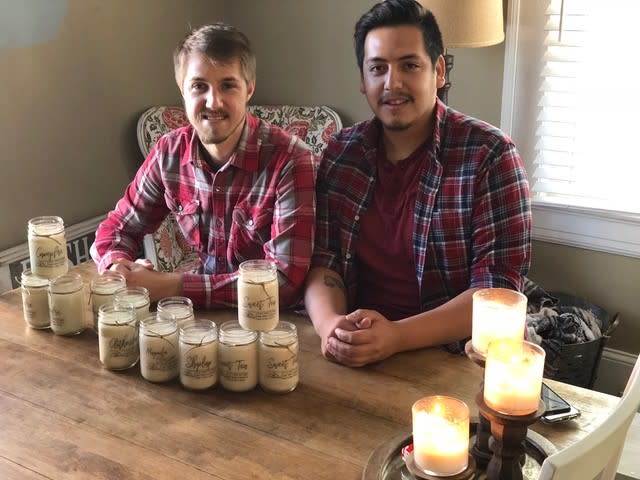 The candle makers for CA Homestead posing with some of their products.